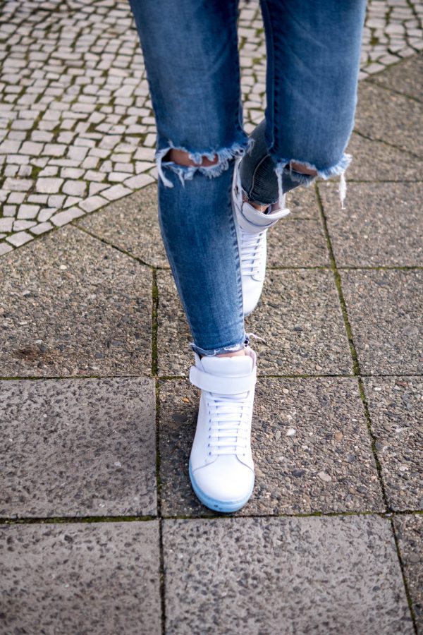 white sneakers with blue sole