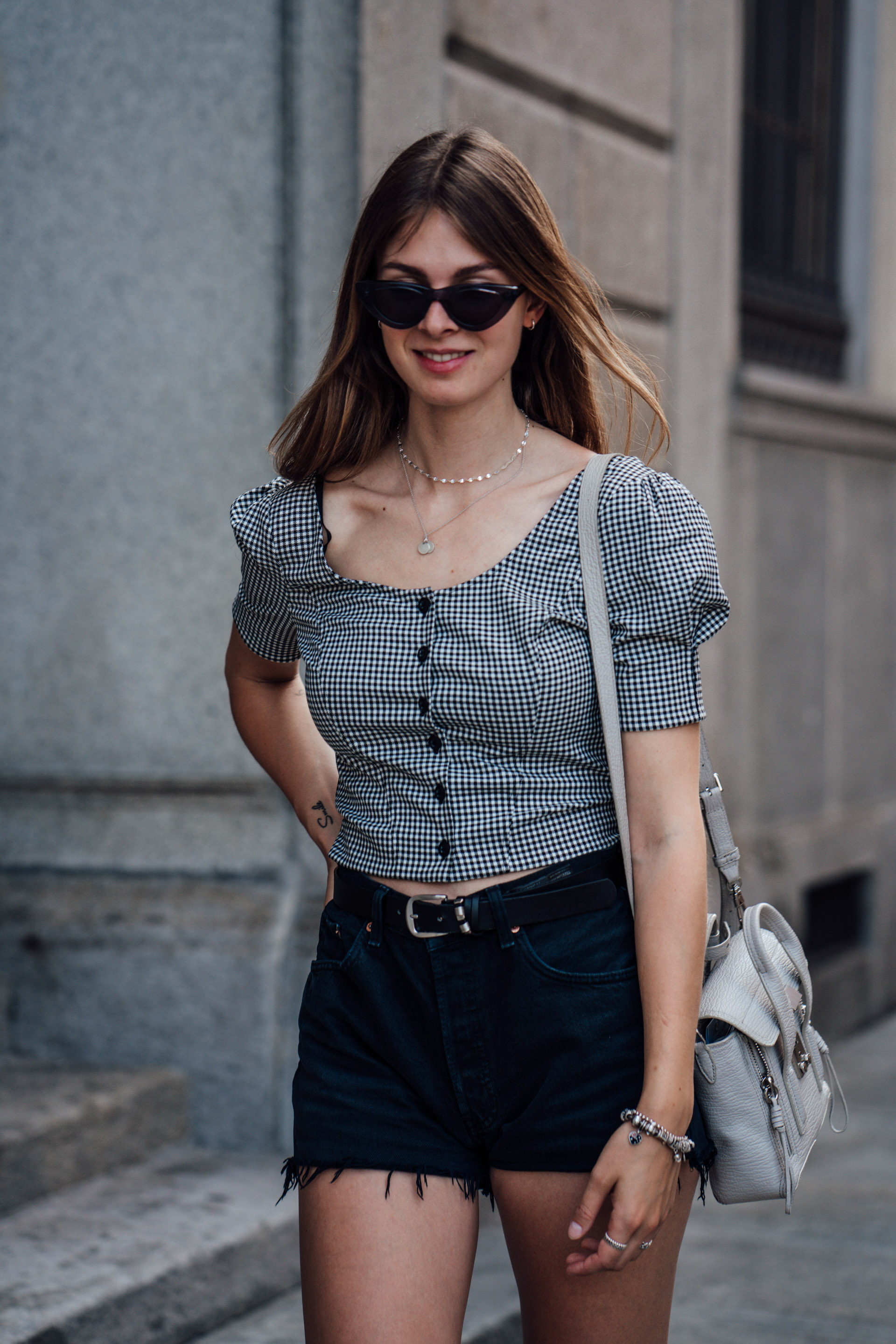 Travel Outfit: Gingham Blouse combined with black Denim Shorts
