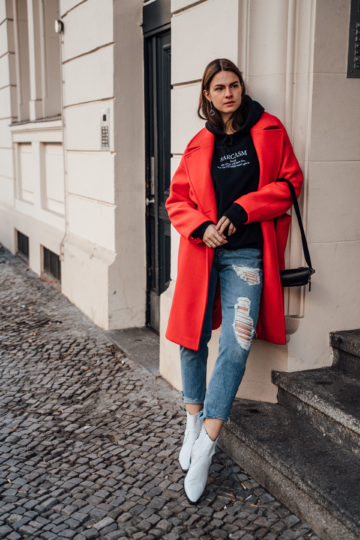 red coat combined with blue jeans
