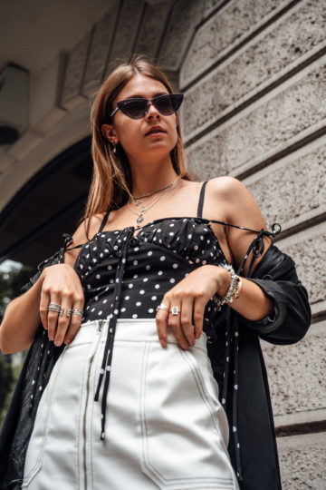 Combining a polka dot top with a white skirt