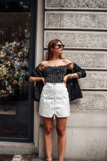 Combining a polka dot top with a white skirt