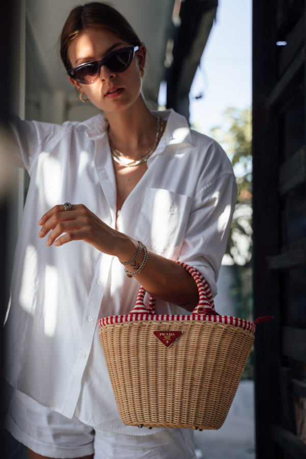 Combining a Prada basket bag with an all-white outfit
